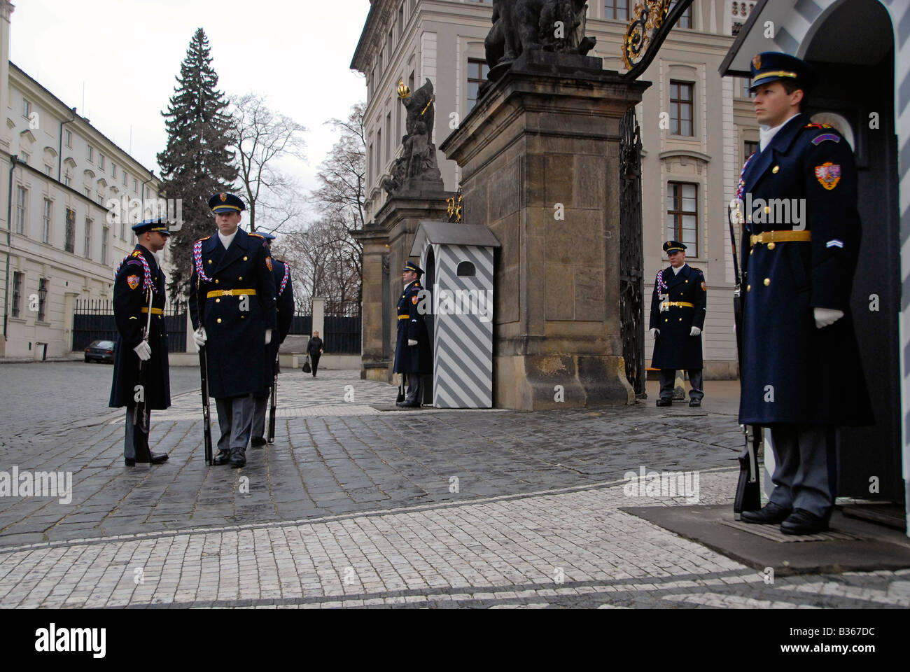 Castle guards stand firm during changing of guards process at the main entrance to Prague Castle in Czech republic Stock Photo