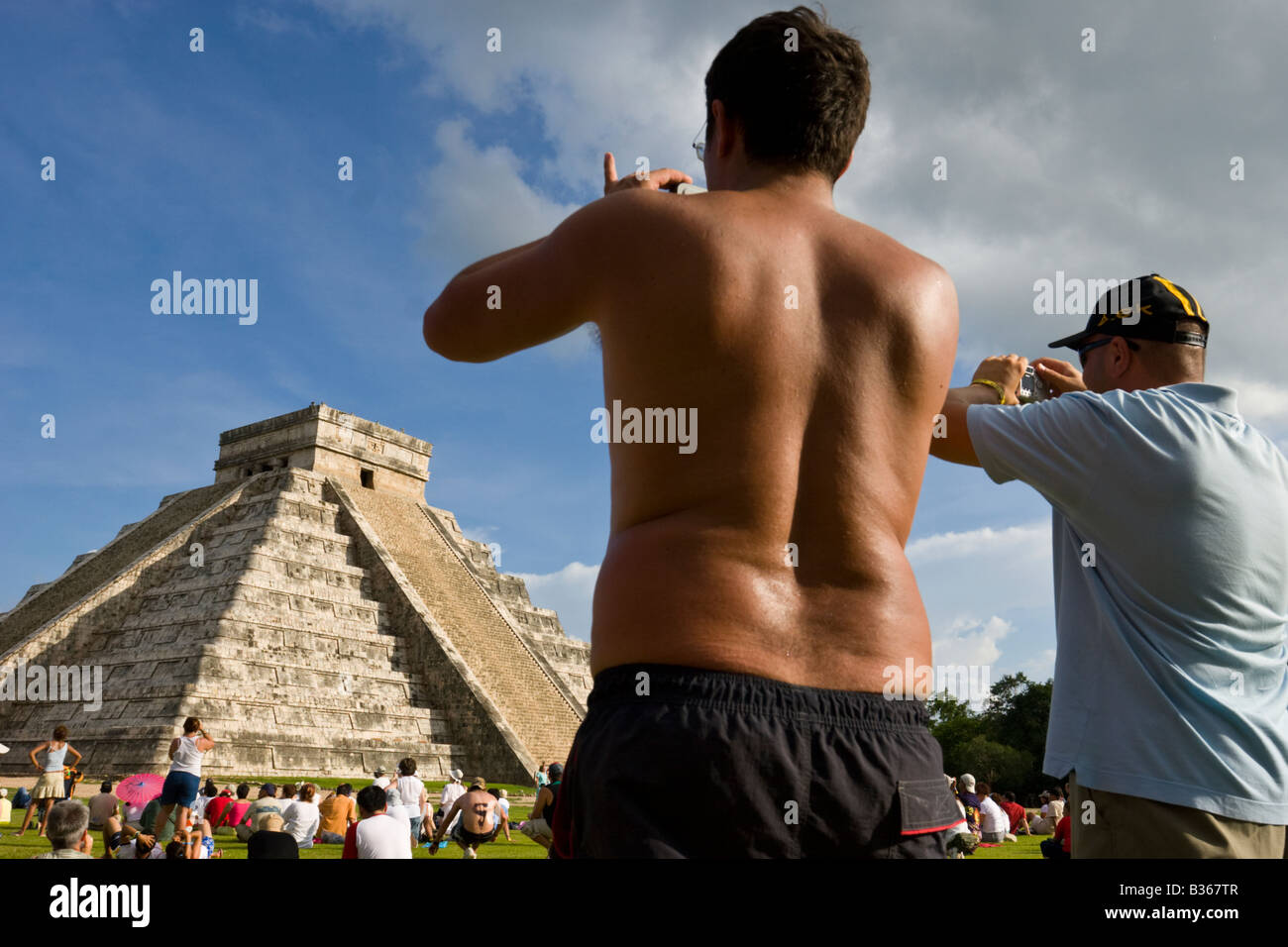 Tourists viewing El Castillo Pyramid of Kukulcan 'The Castle' during the fall equinox at the Mayan site of Chichen Itza, Mexico. Stock Photo