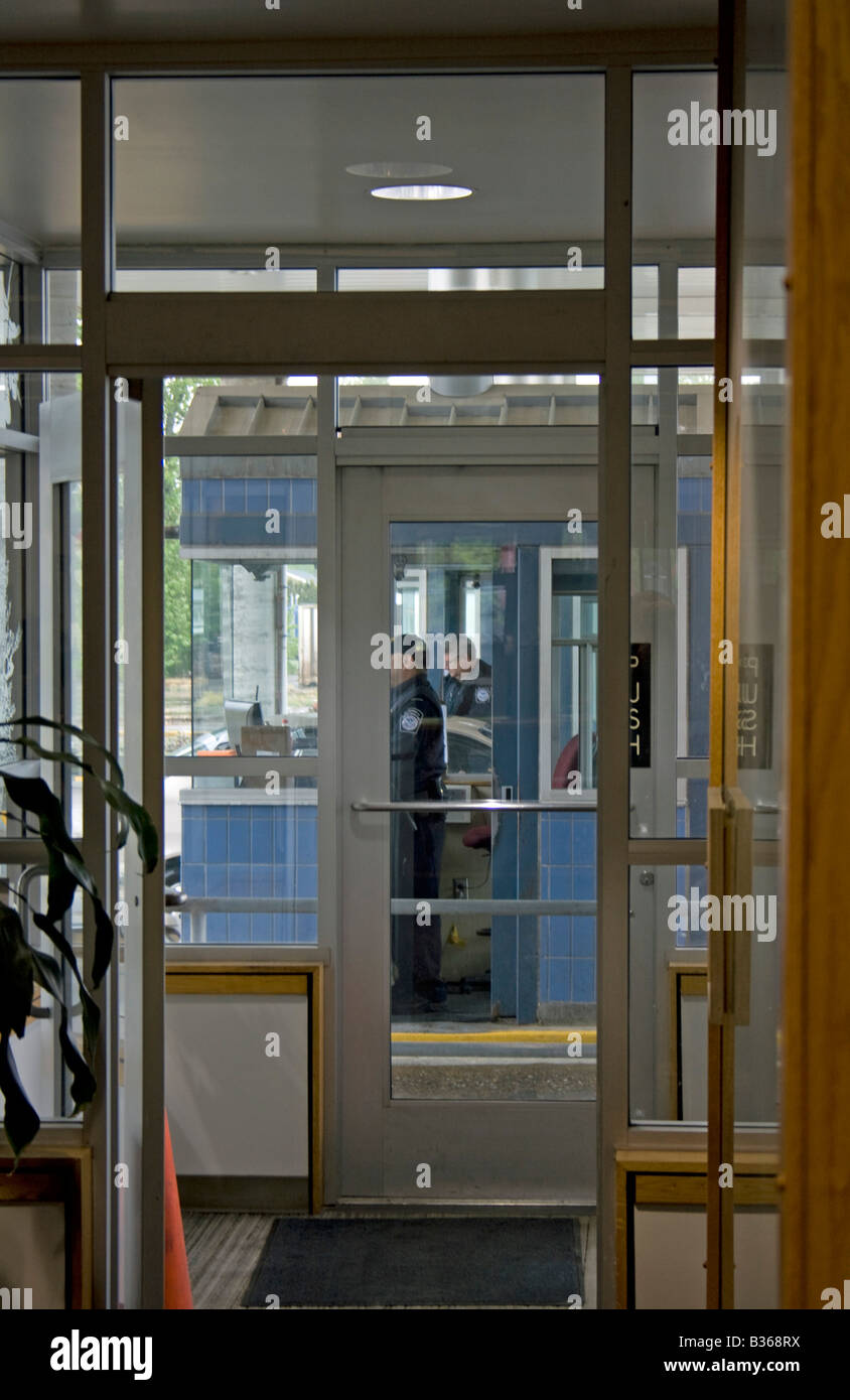 Border Officer questions and or inspects a commercial entrant into the US Port Of Entry Sumas Washington. Stock Photo