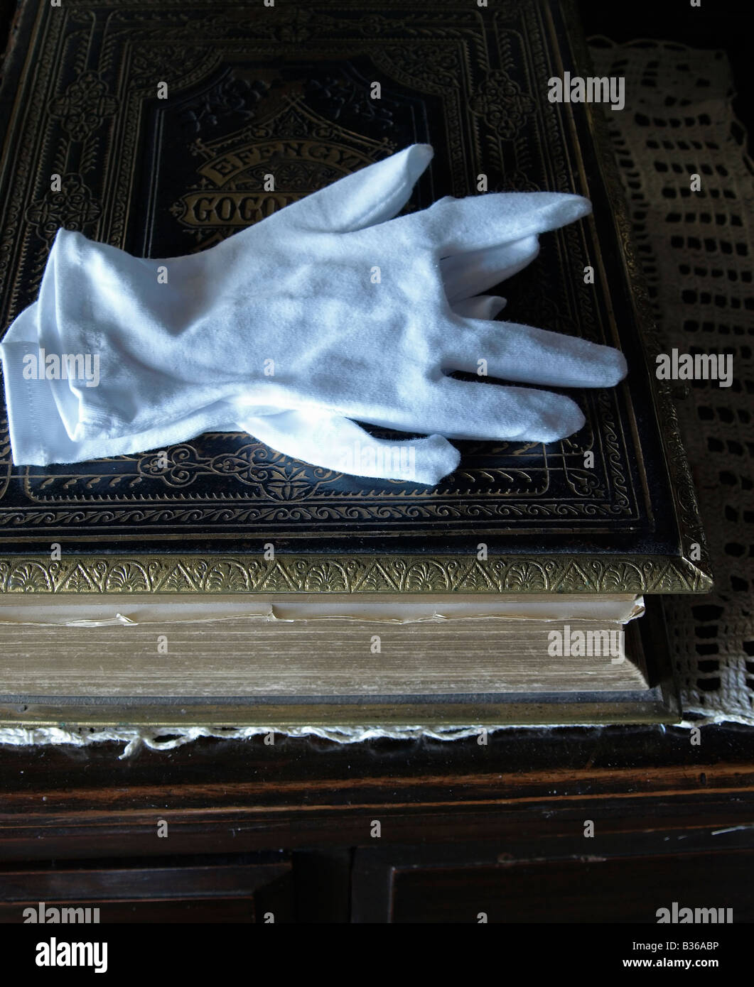 White gloves on a welsh bible Stock Photo Alamy