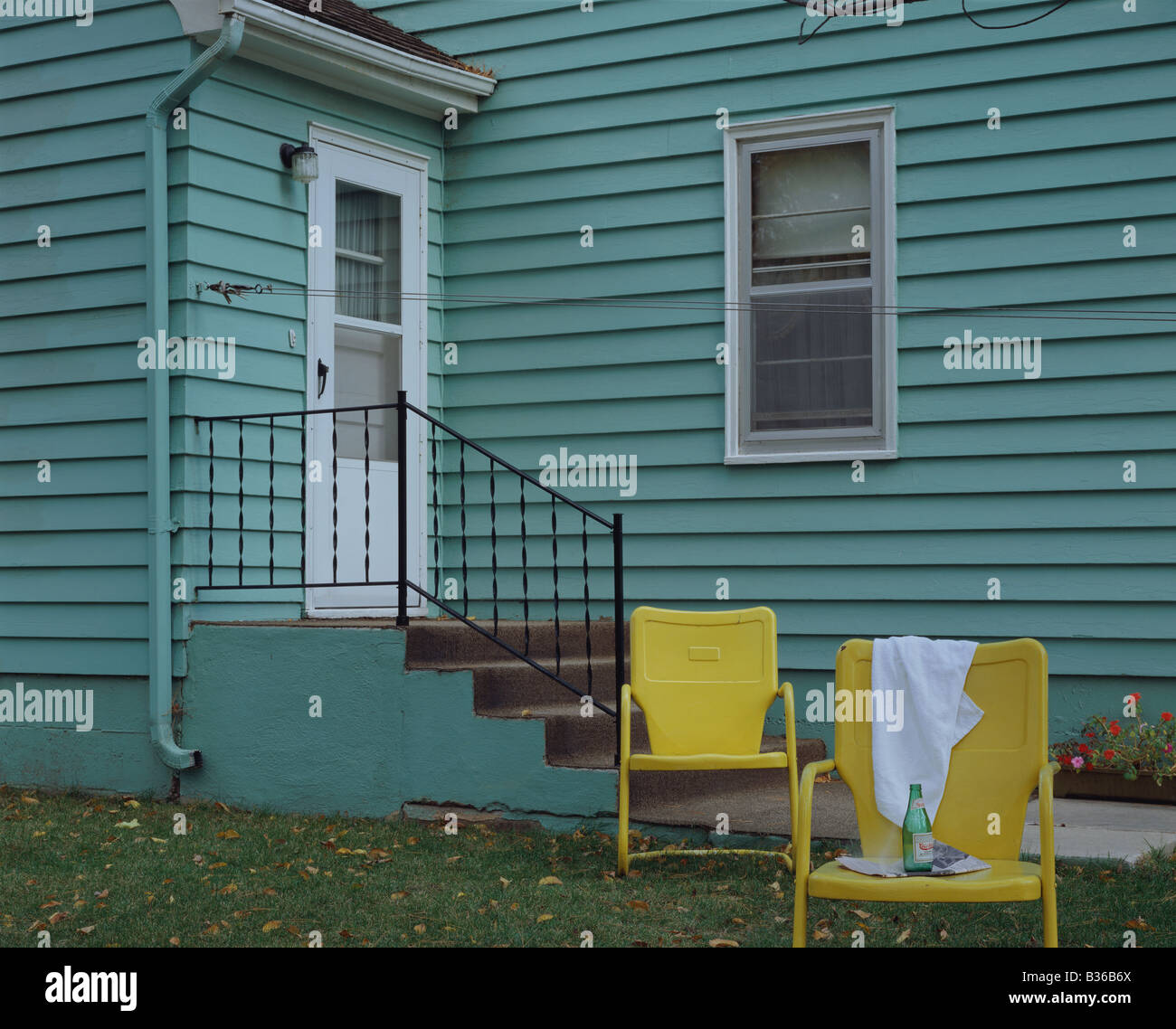 Green color house and yellow chairs Stock Photo