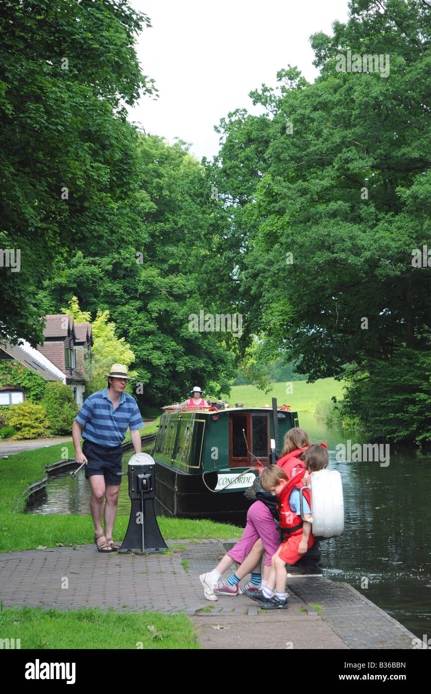 Family on a canal holiday passing through Hyde Lock on the Staffordshire and Worcestershire Canal Kinver S Staffordshire England Stock Photo
