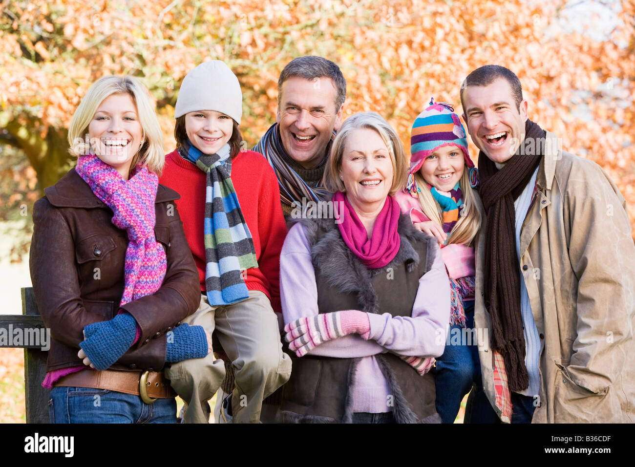 Family outdoors in park smiling (selective focus) Stock Photo