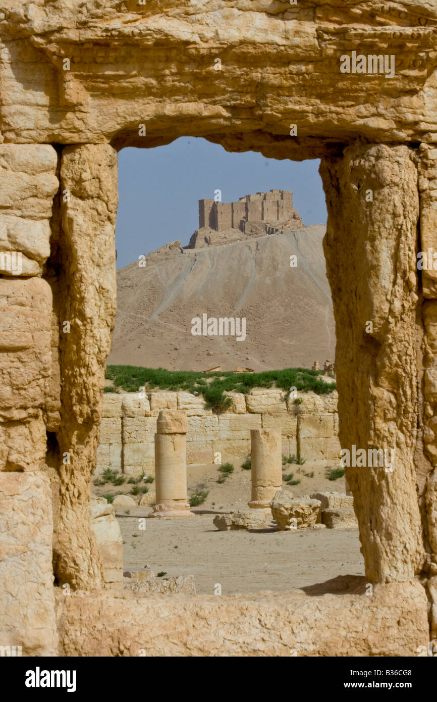 Arab Castle Qalaat Ibn Maan through the Roman Ruins of Palmyra in Syria Stock Photo