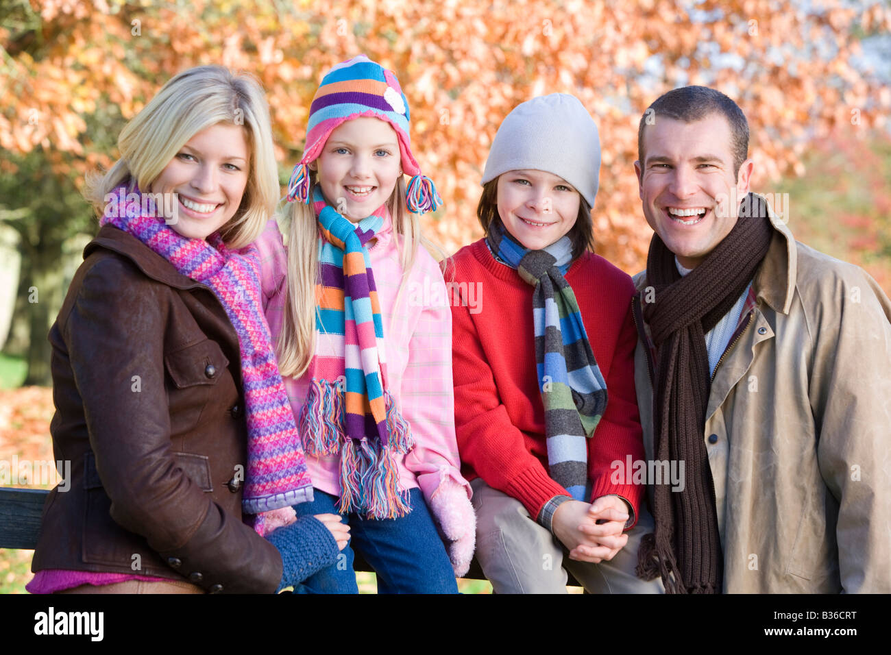 Family outdoors at park smiling (selective focus) Stock Photo