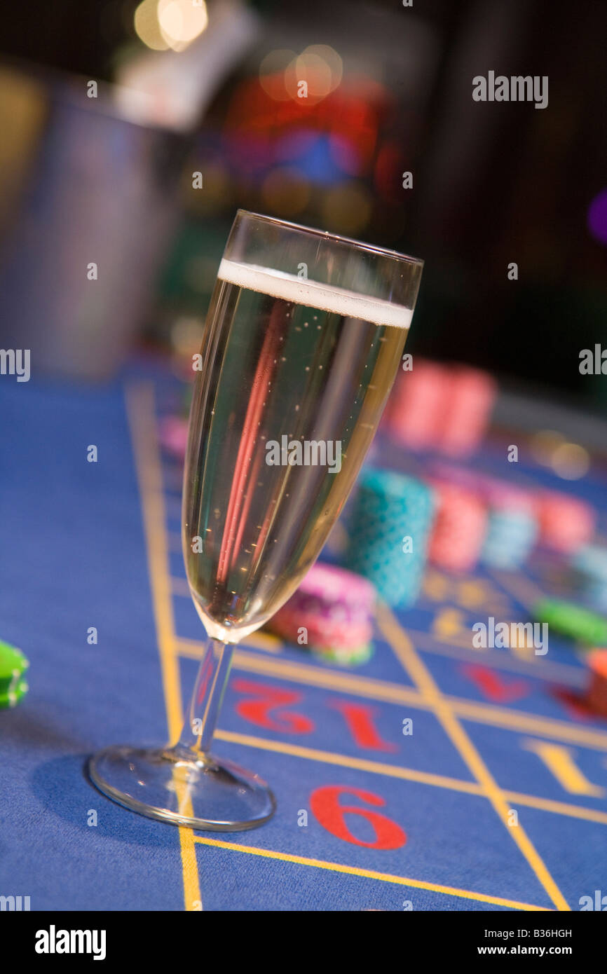 Champagne flute sitting on roulette table (selective focus) Stock Photo