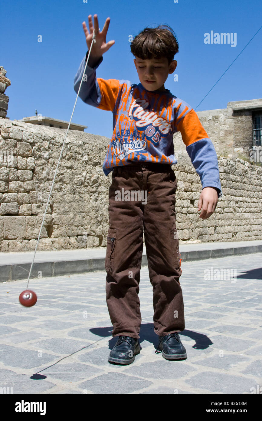 Syrian Boy Spinning a Top in the Old City in Aleppo Syria Stock Photo