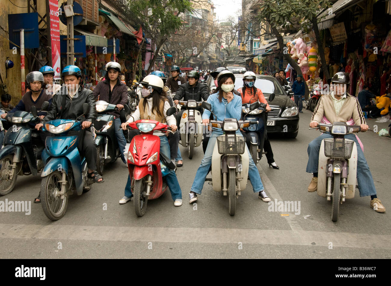Hanoi moped traffic wait at the traffic lights in a side street Vietnam