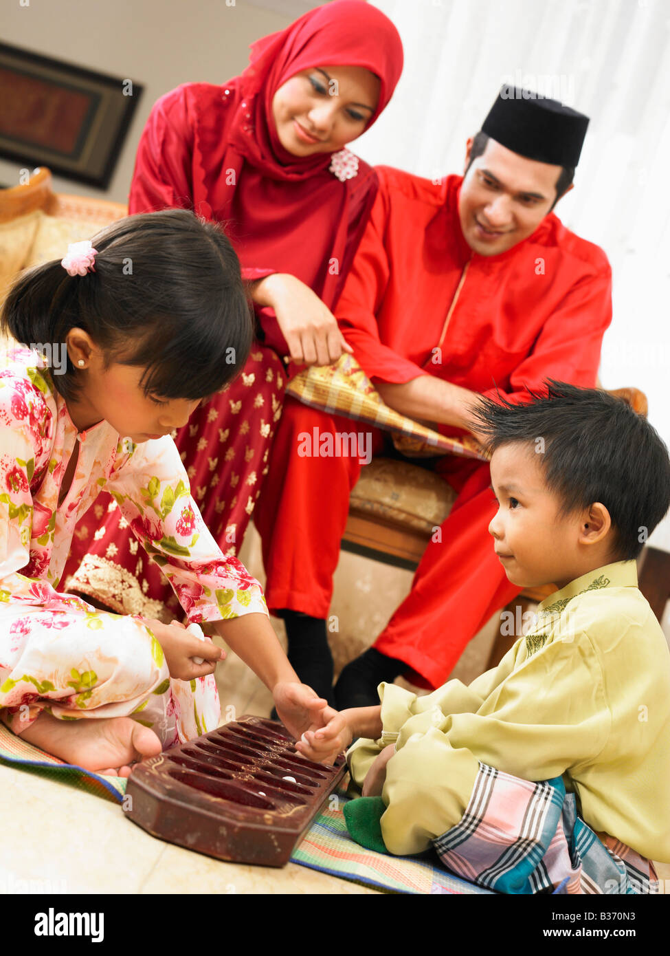 Family of four playing together Stock Photo