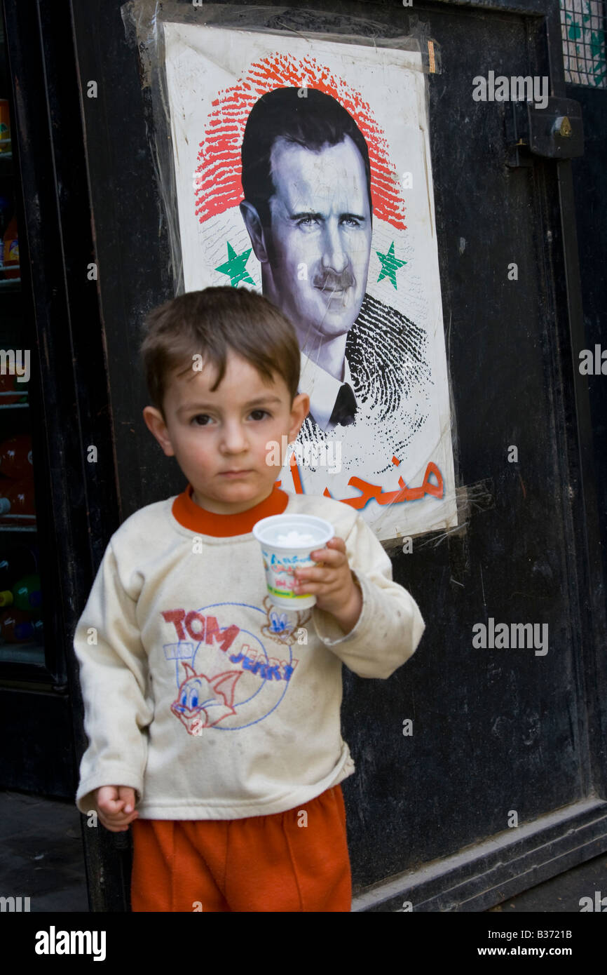 Young Syrian Boy and a Poster of Bashar Assad in Aleppo Syria Stock Photo