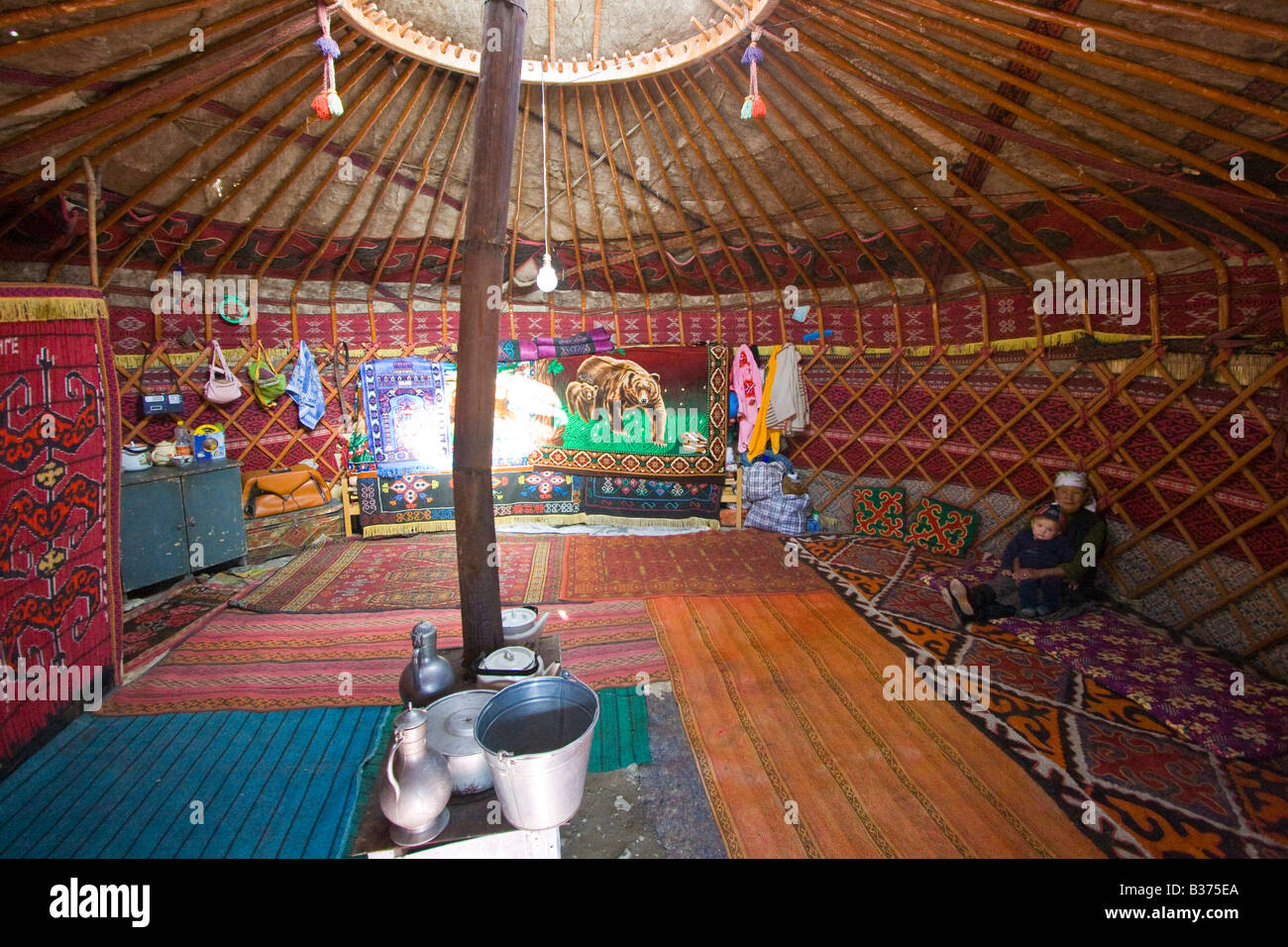 Ethnically Kyrgyz Takij Grandmother and Baby Boy in a Yurt in Jalang Village in the Pamirs in Tajikistan Stock Photo