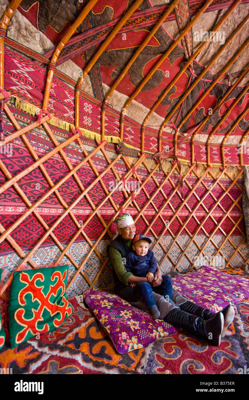 Ethnically Kyrgyz Takij Grandmother and Baby Boy in a Yurt in Jalang Village in the Pamirs in Tajikistan Stock Photo