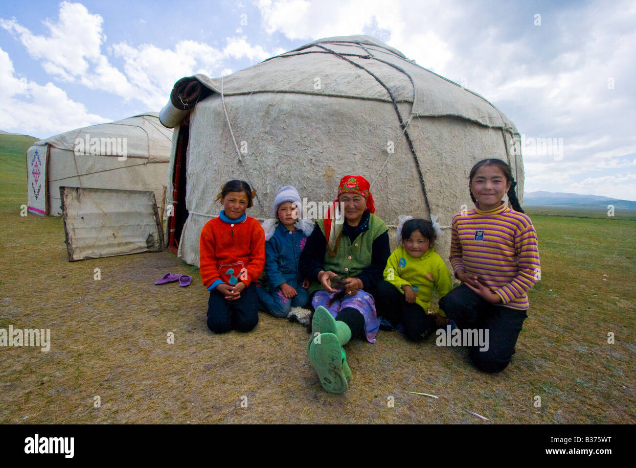Kyrgyz Family in front of a Yurt on Song Kul Lake in Kygryzstan Stock Photo