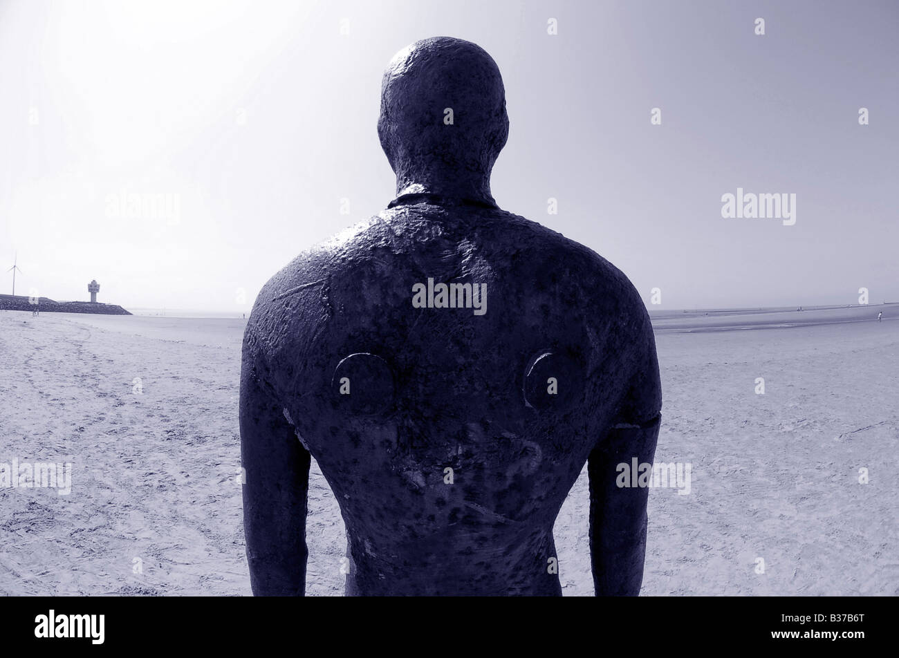 another place anthony gormley crosby beach liverpool merseyside cast-iron life-size figure art staring horizon fisheye lens Stock Photo