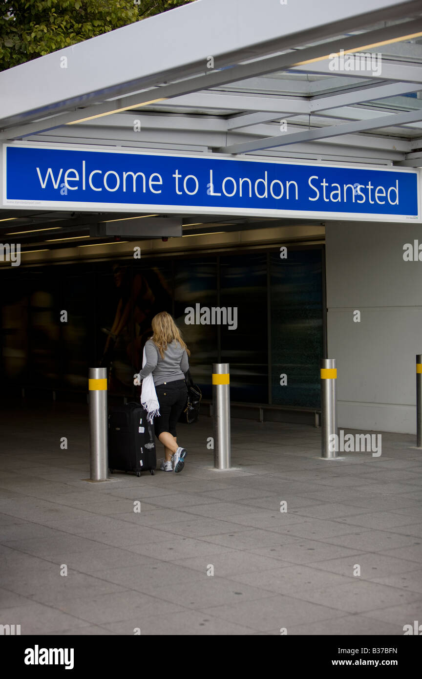 A passenger arriving at London Stansted Airport in Essex UK operated by BAA the British Airport Authority Stock Photo