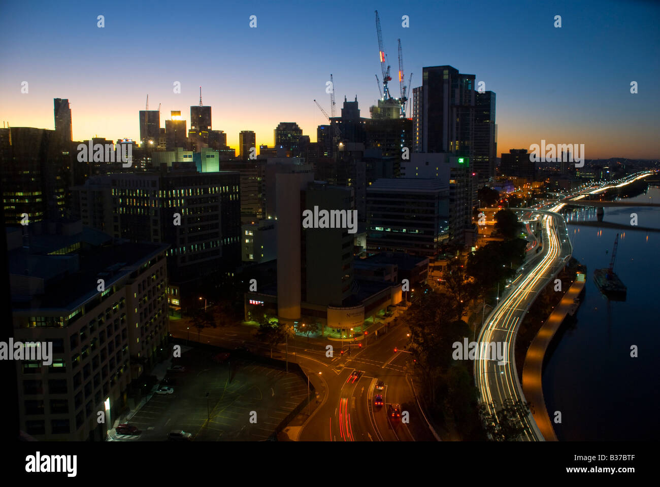 Brisbane city skyline along the Brisbane River at sunrise Stock Photo