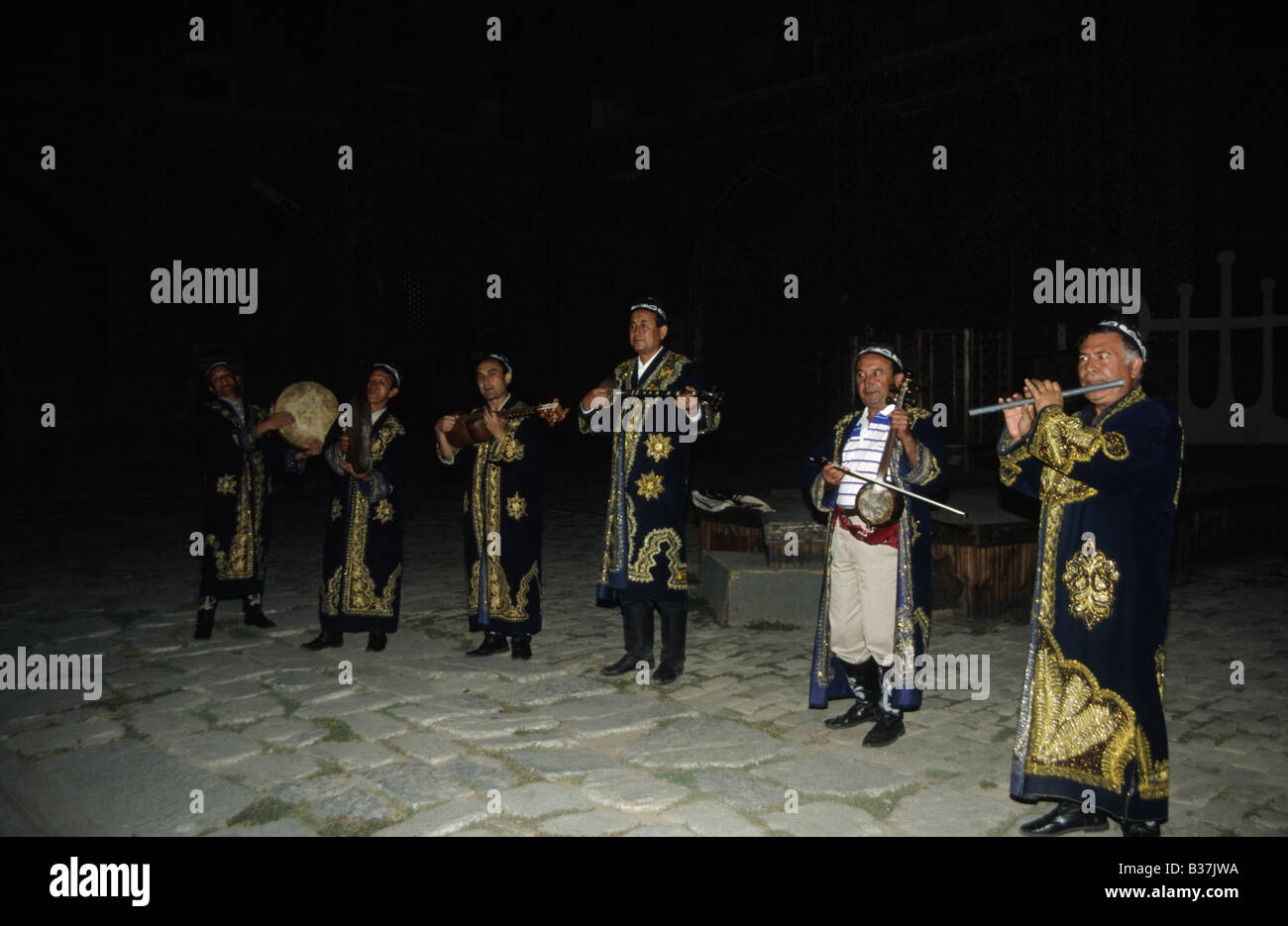 Group of musicians band In dark robes with gold decoration Musical instruments SAMARKAND UZBEKISTAN Stock Photo