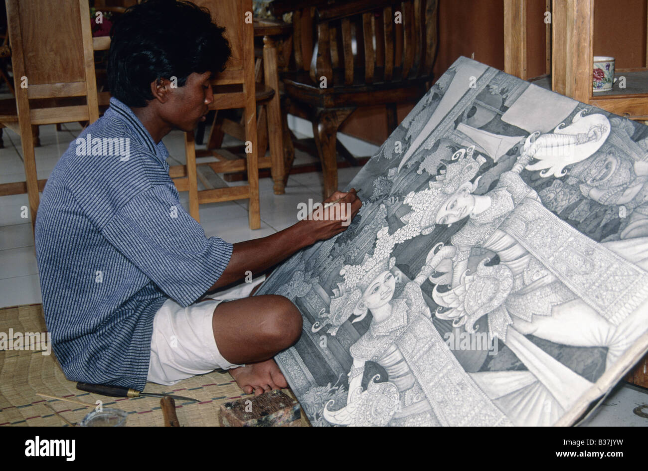 Artist working on painting drawing Black medium CELUK BALI INDONESIA