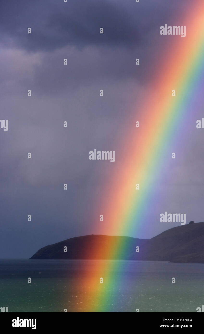 A rainbow with Lyttelton Harbour, Canterbury, New Zealand in the background Stock Photo