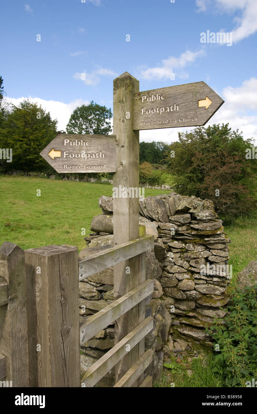 Wooden public footpath sign in summer Hawkshead Cumbria England UK United Kingdom GB Great Britain Stock Photo