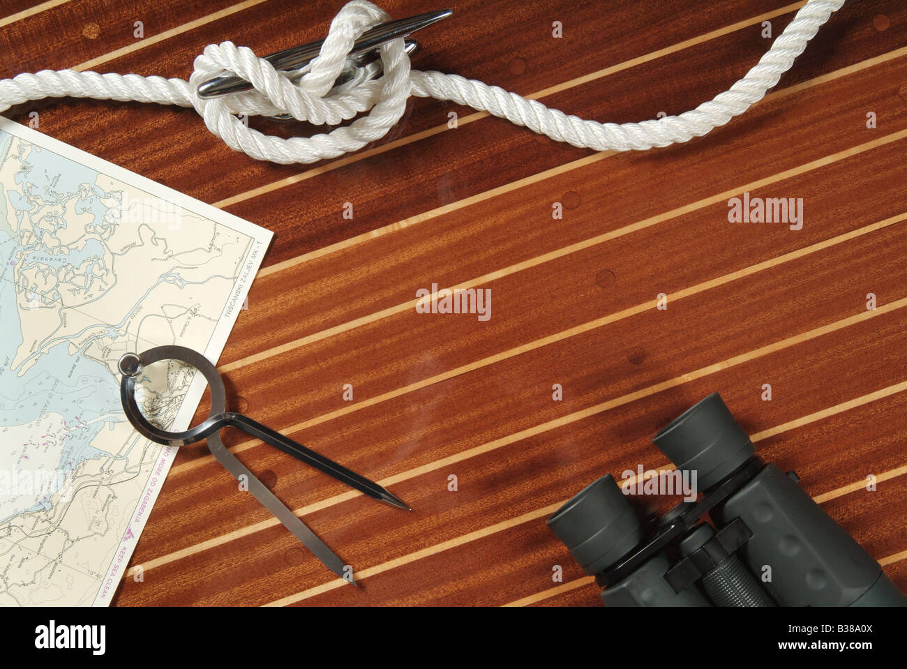 Nautical divider on a chart, rope and binoculars Stock Photo Alamy