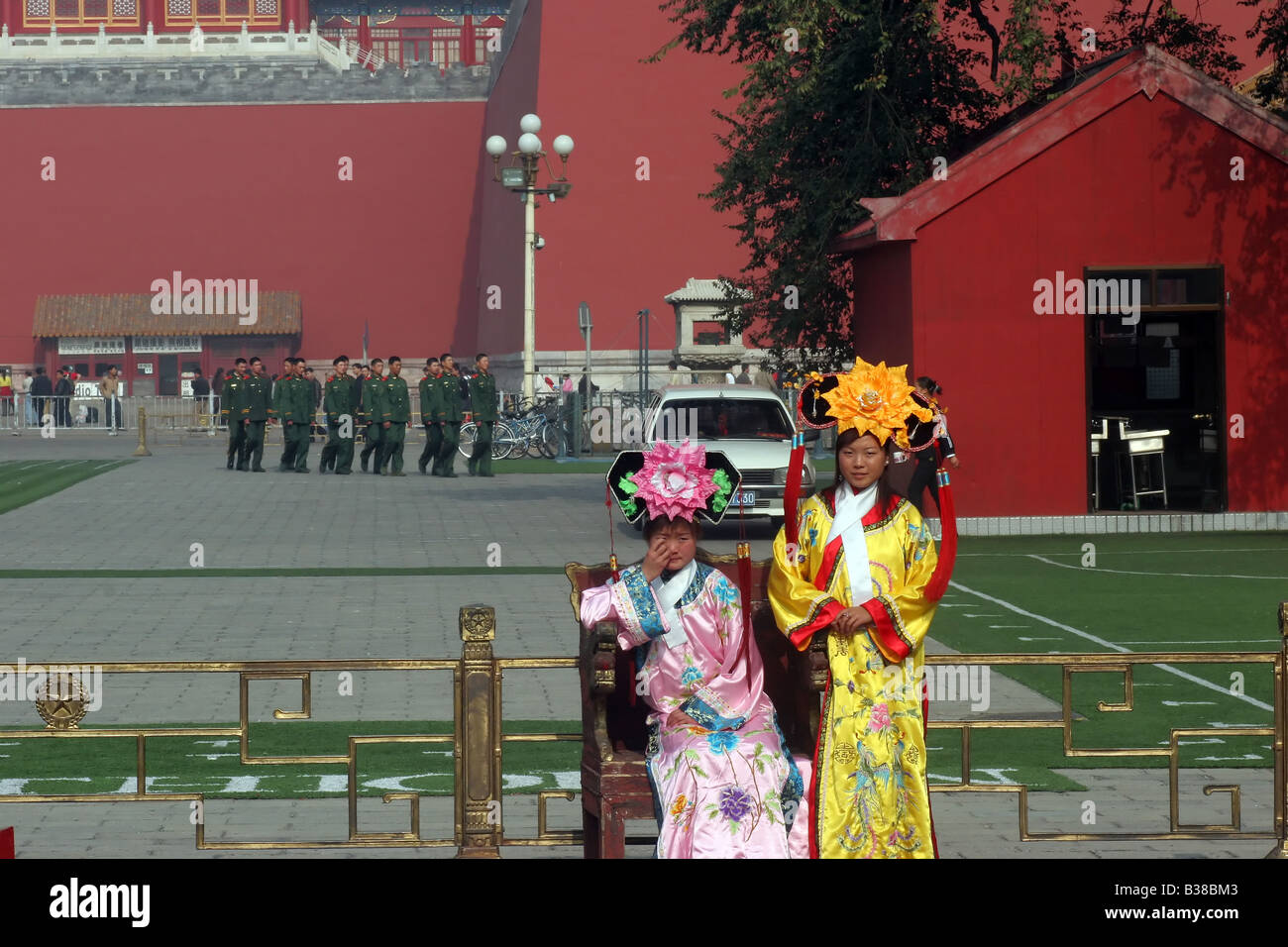 Two young girls dressed in traditional costume stand in Tiananmen