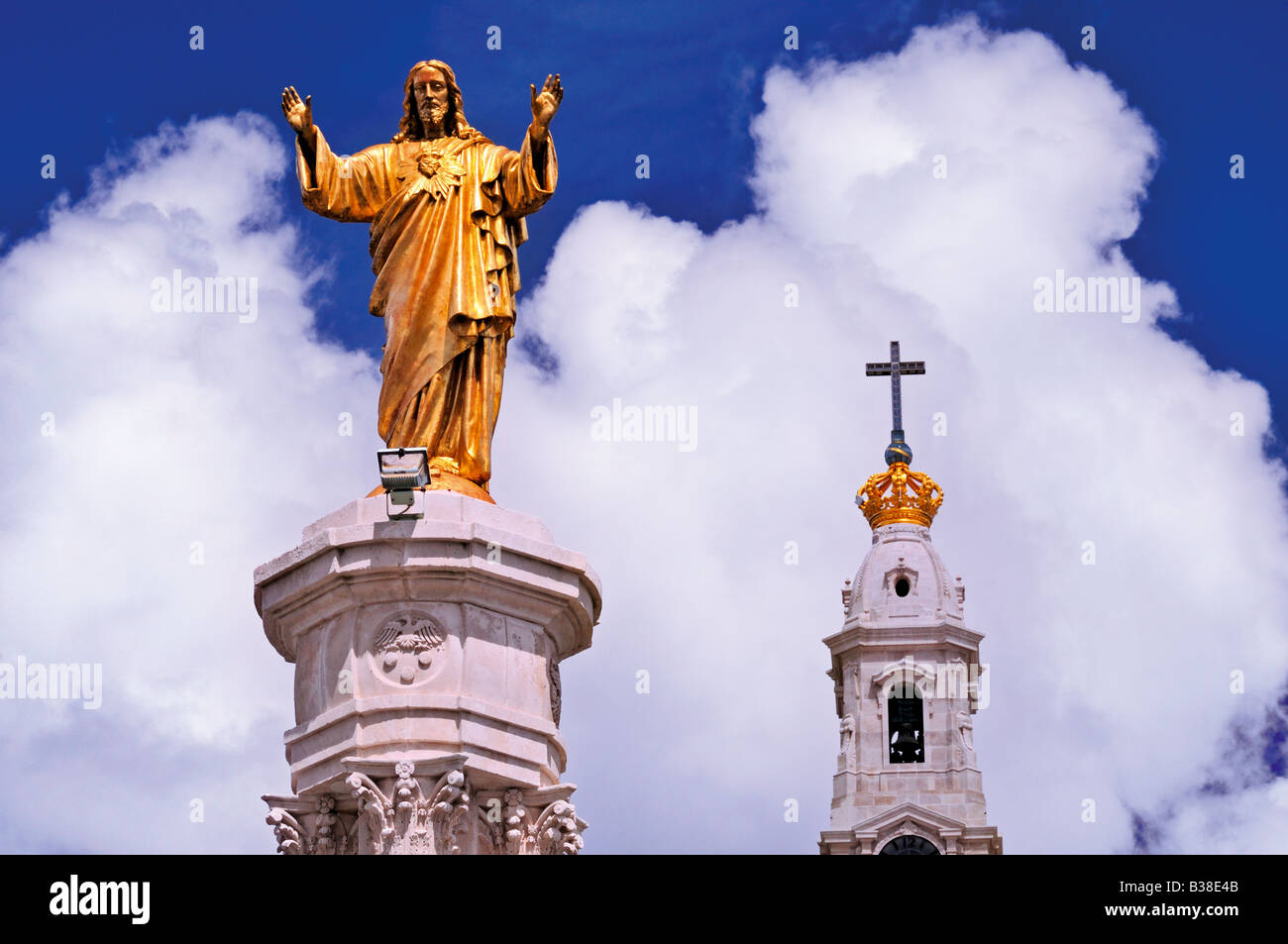 Statue of Christ and tower of the basilica in the clouds, Fatima, Portugal Stock Photo