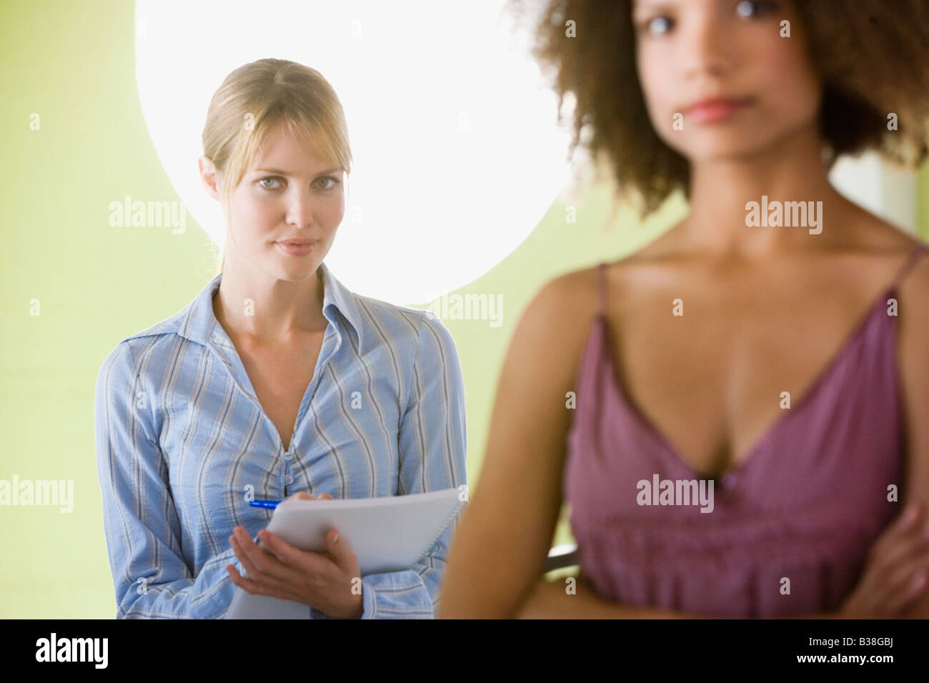 Businesswoman with coworker in foreground Stock Photo