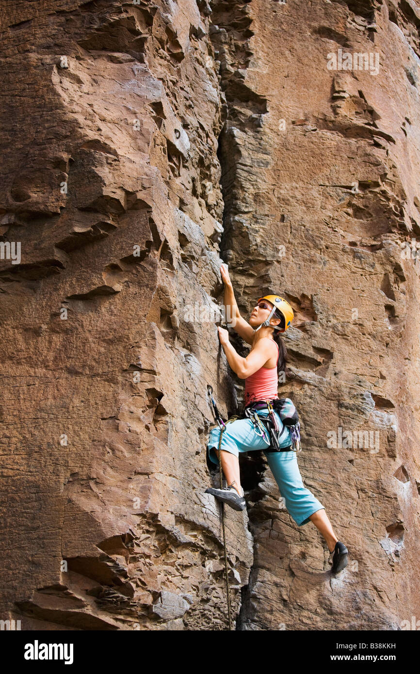 Asian woman rock climbing Stock Photo - Alamy