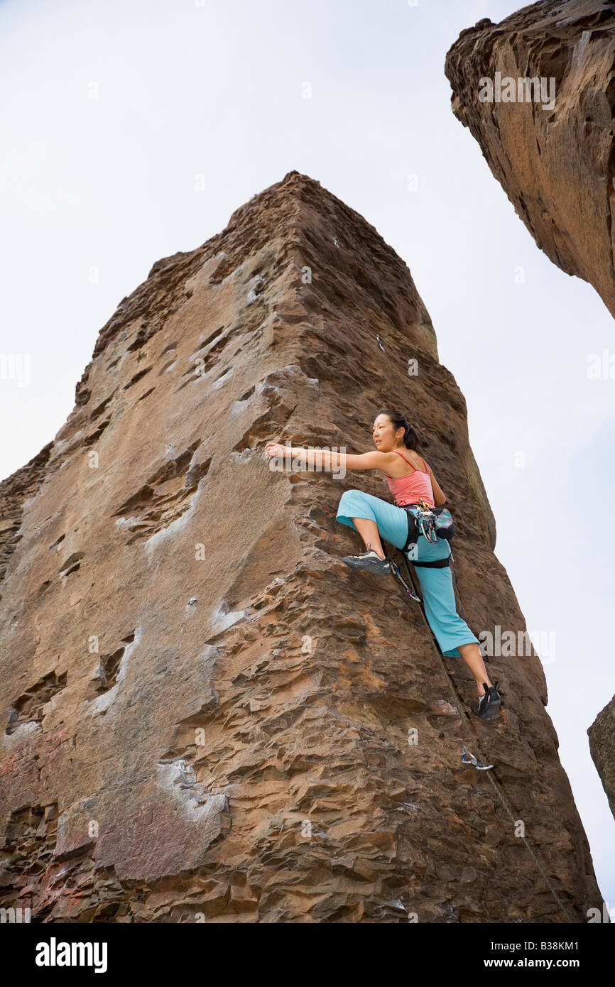 Asian woman rock climbing Stock Photo - Alamy