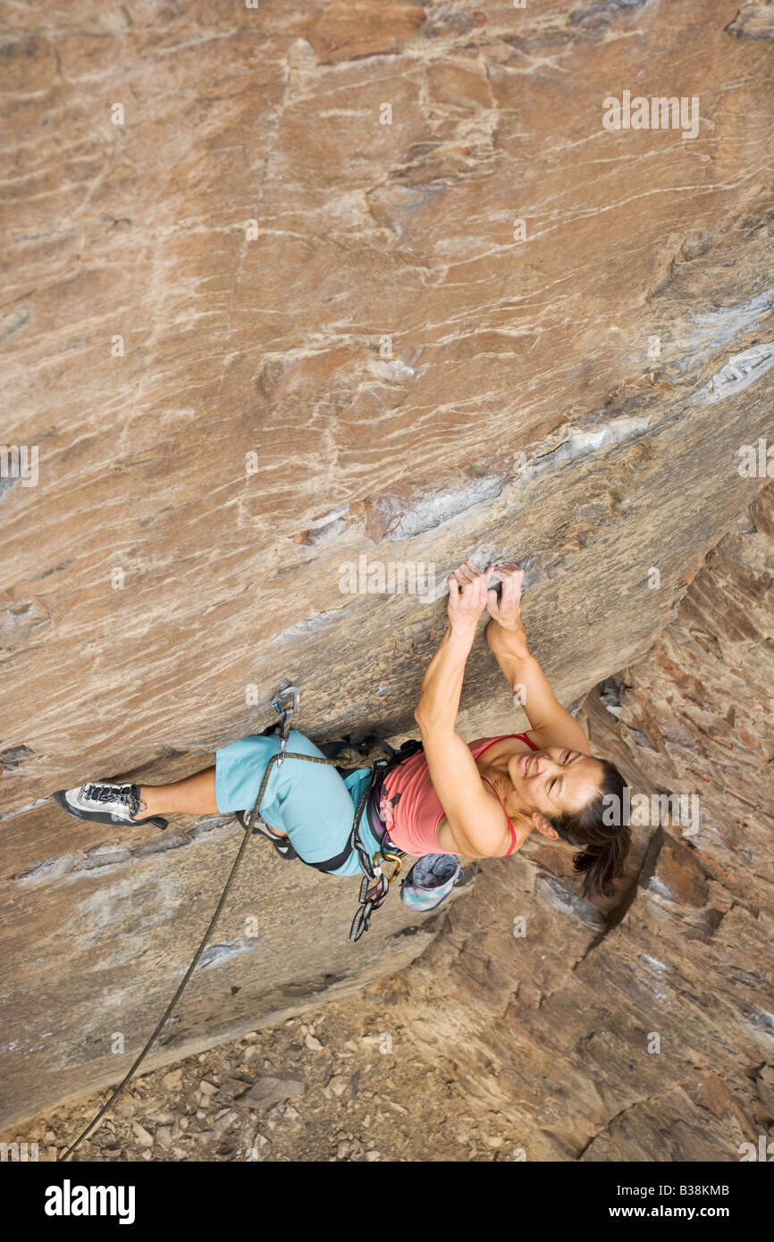 Asian woman rock climbing Stock Photo - Alamy