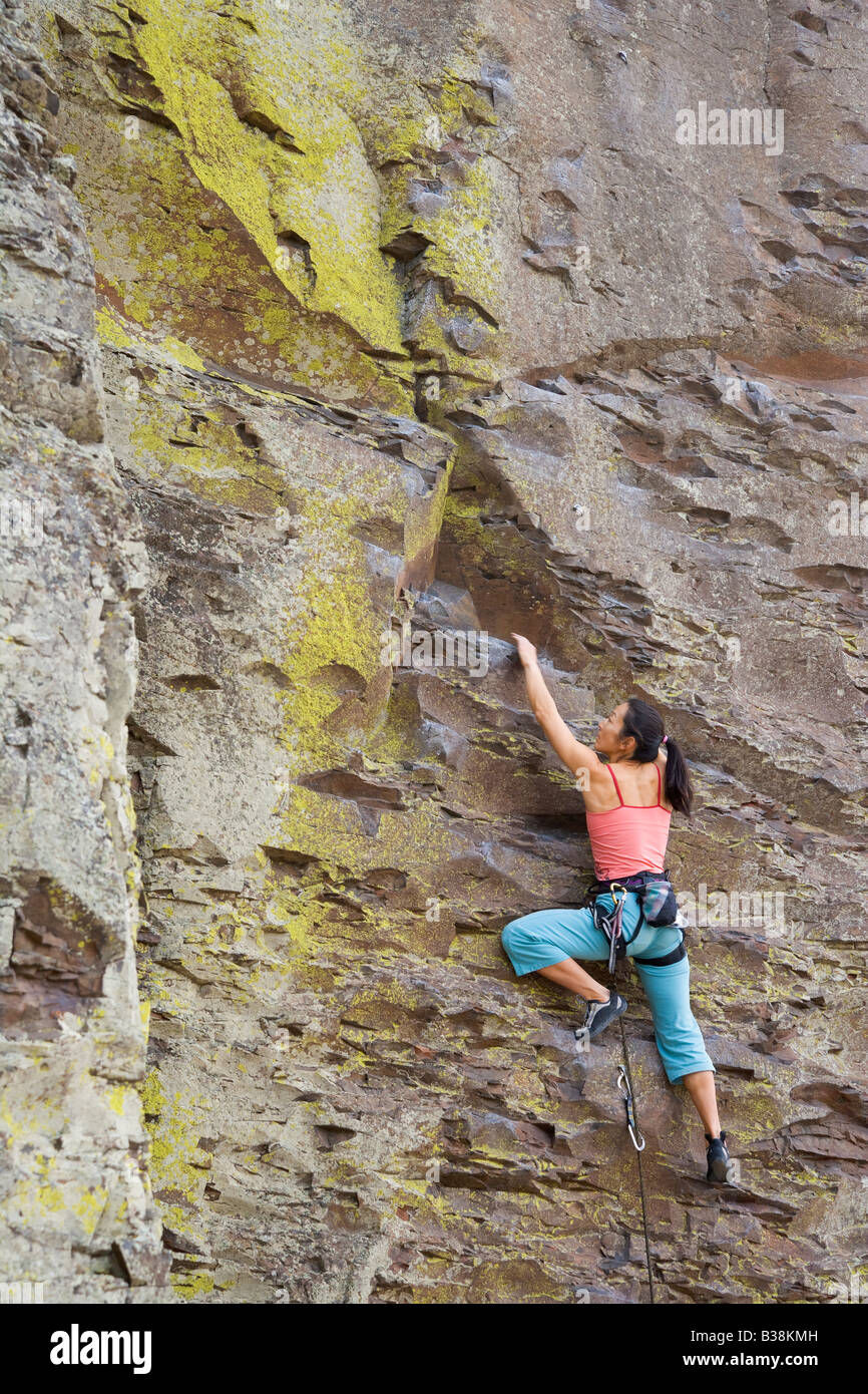 Asian woman rock climbing Stock Photo - Alamy