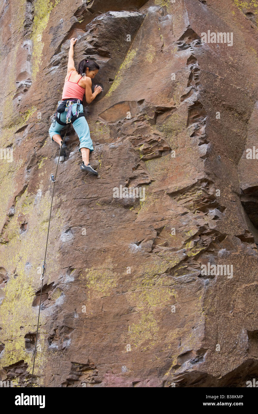 Asian woman rock climbing Stock Photo - Alamy