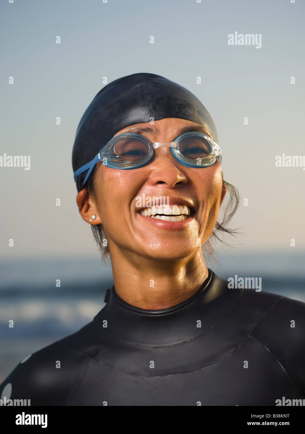 Asian woman wearing wetsuit and goggles Stock Photo - Alamy