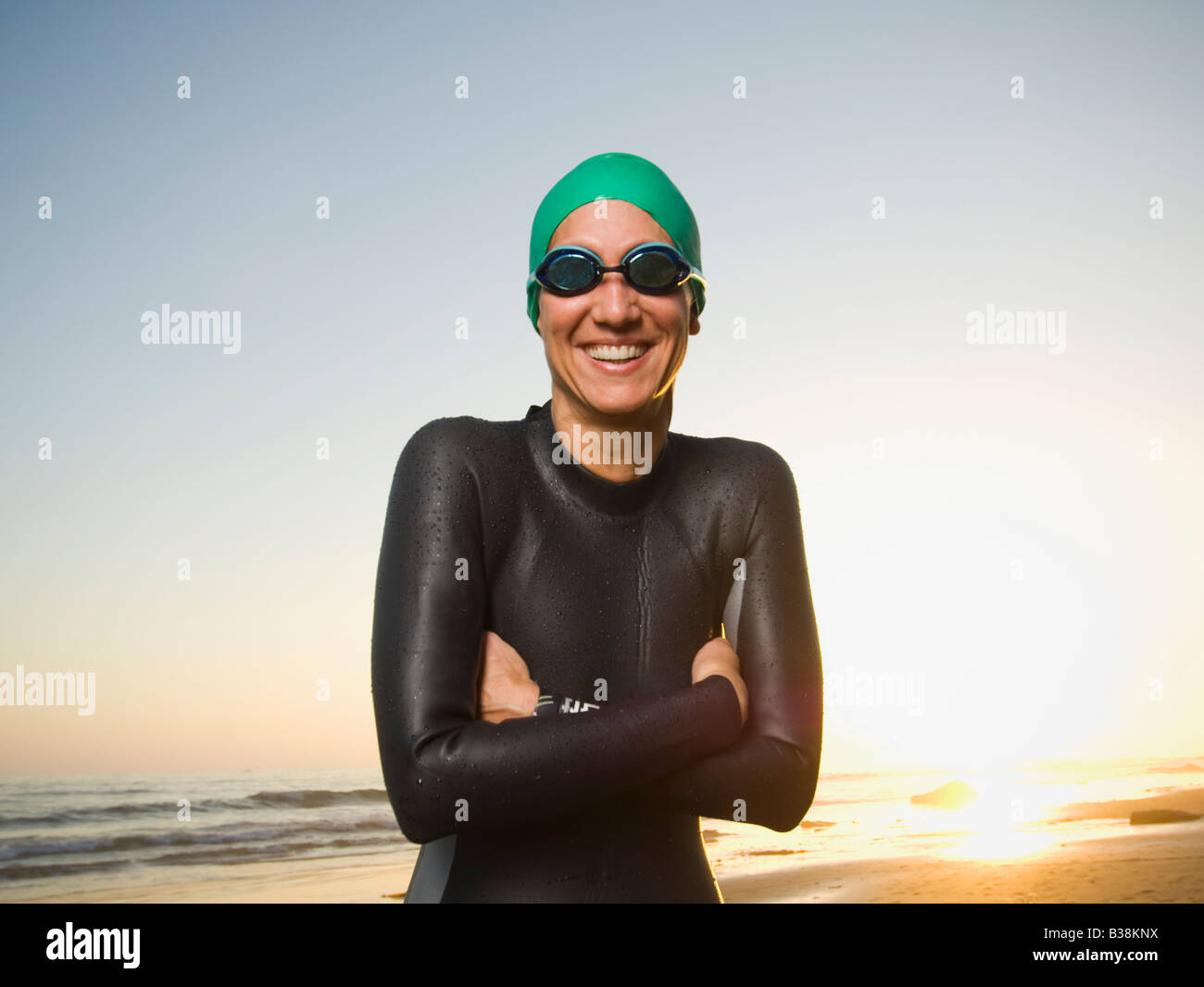 Hispanic woman wearing wetsuit and goggles Stock Photo - Alamy