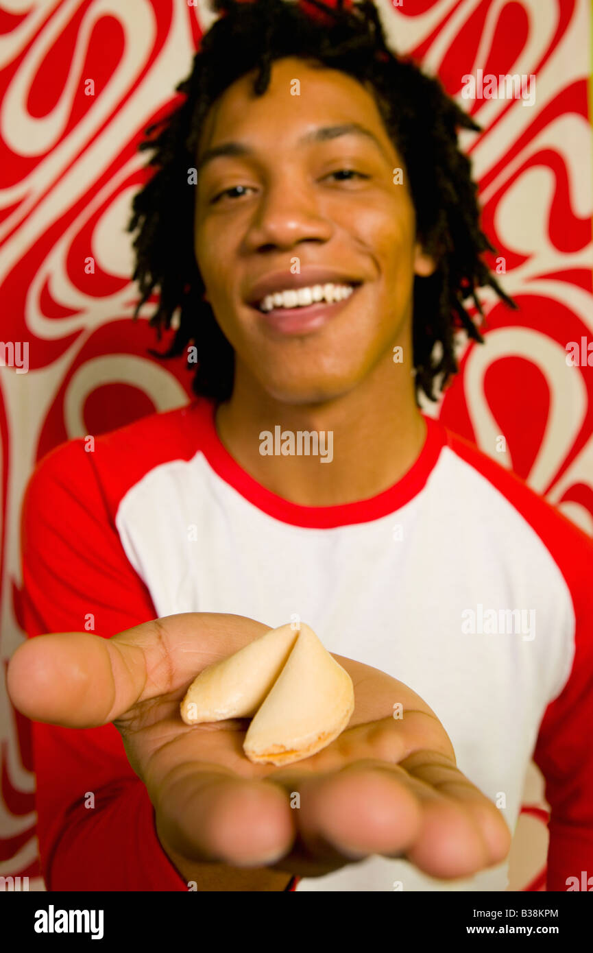African man holding fortune cookie Stock Photo Alamy