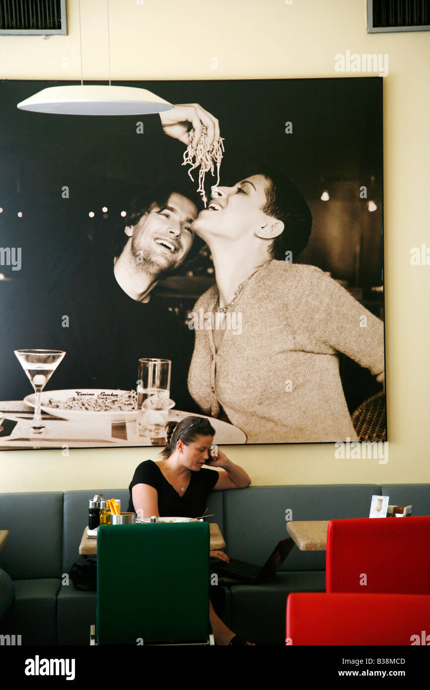 Aug 2008 Woman sitting at the trendy Pasta Caffe in Vezenska 1 street Josefov Prague Czech
