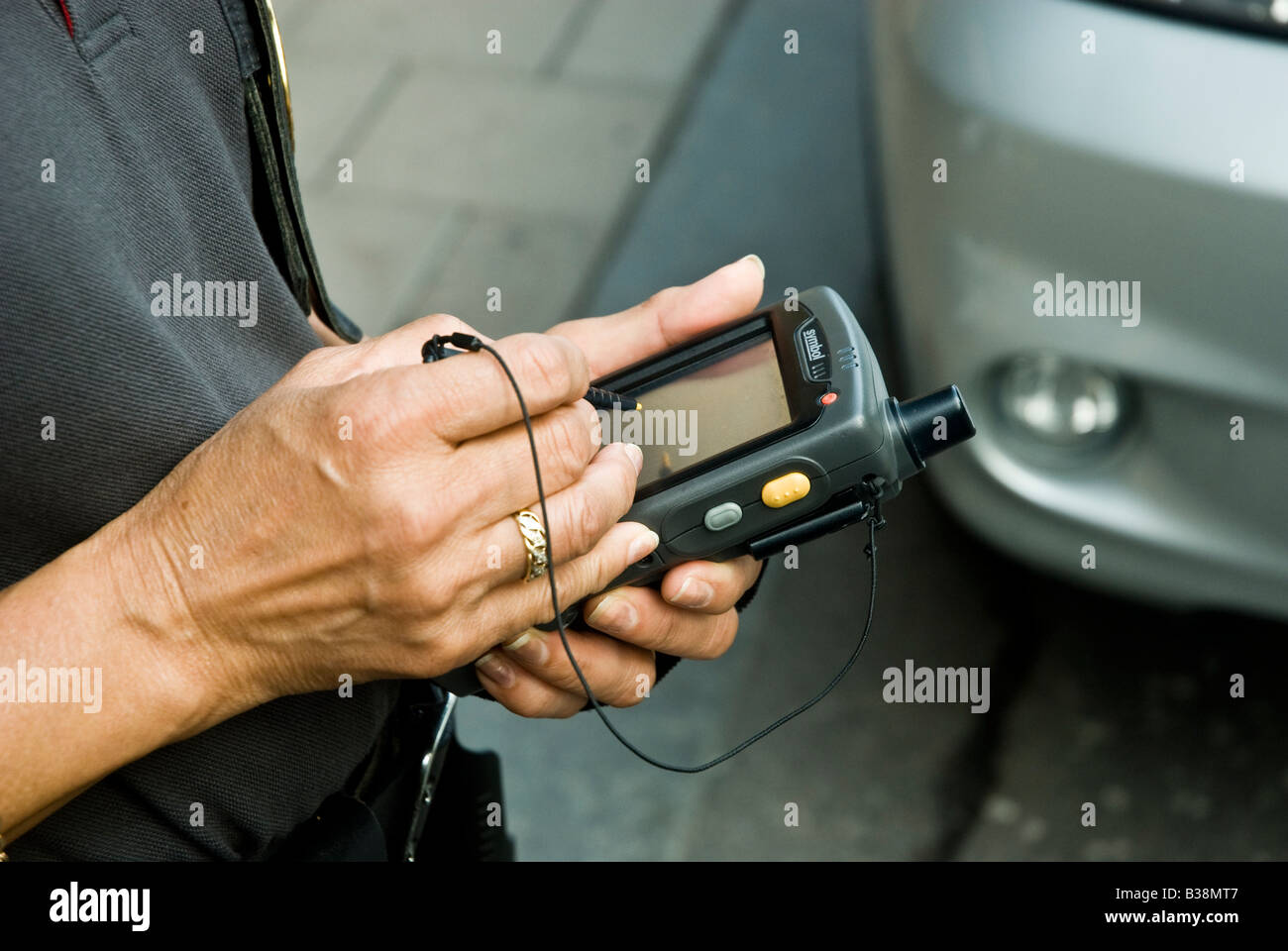 Stockholm traffic warden with a handheld PDA or Personal digital assistant Stock Photo