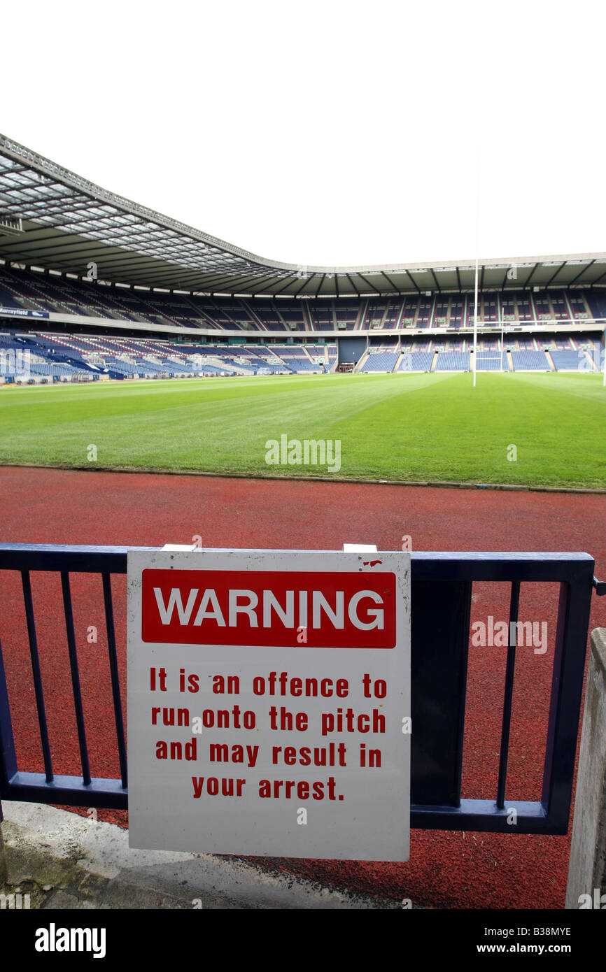 Sign at Murrayfield Stadium in Edinburgh, Scotland, UK, warning fans not to run onto the pitch as they may face arrest Stock Photo