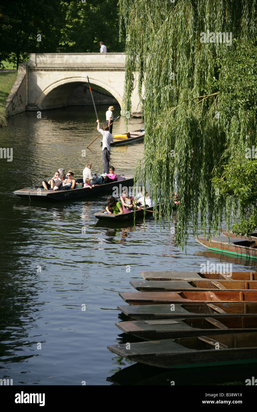 City of Cambridge, England. Hire punts moored on the River Cam with tourists pleasure punting in the background. Stock Photo