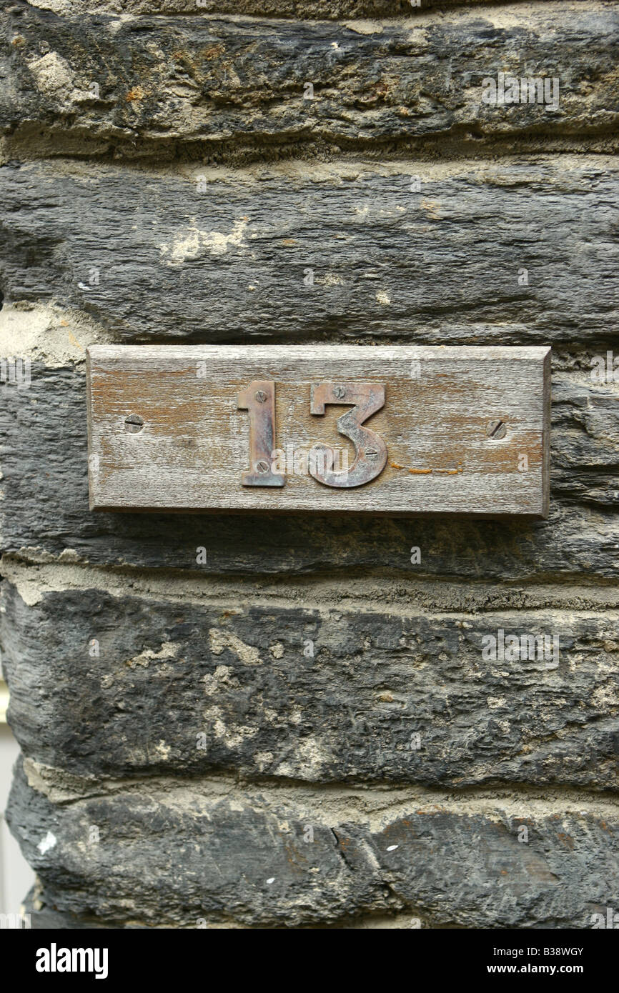 Number Thirteen on wooden door number Stock Photo