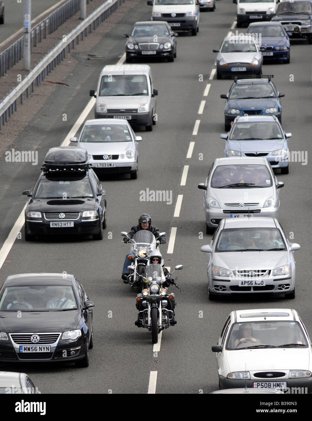 MOTORCYCLISTS FILTERING THROUGH HEAVY TRAFFIC ON THE M6 MOTORWAY,NEAR JUNCTION 11,CANNOCK,STAFFORDSHIRE,UK. Stock Photo