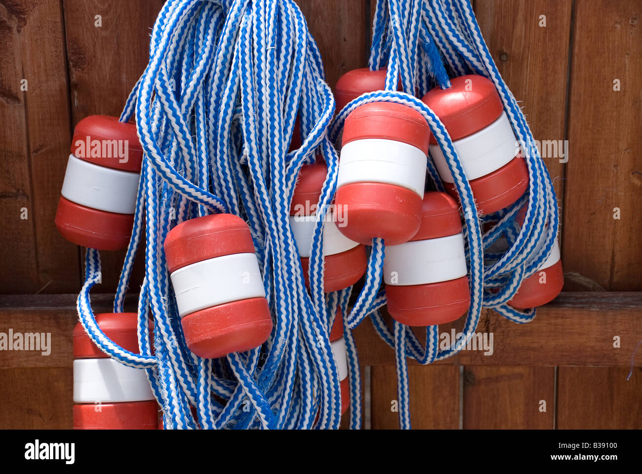 Swimming pool lane floats hang on a fence as their summer storage location Stock Photo Alamy