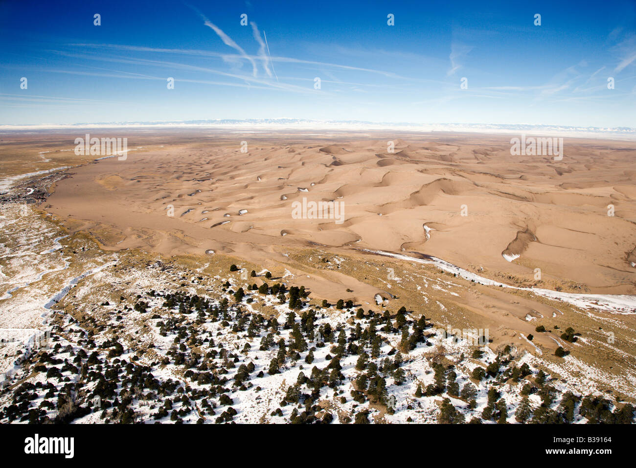 Aerial landscape of snowy plains and dunes in Great Sand Dunes National Park Colorado Stock Photo