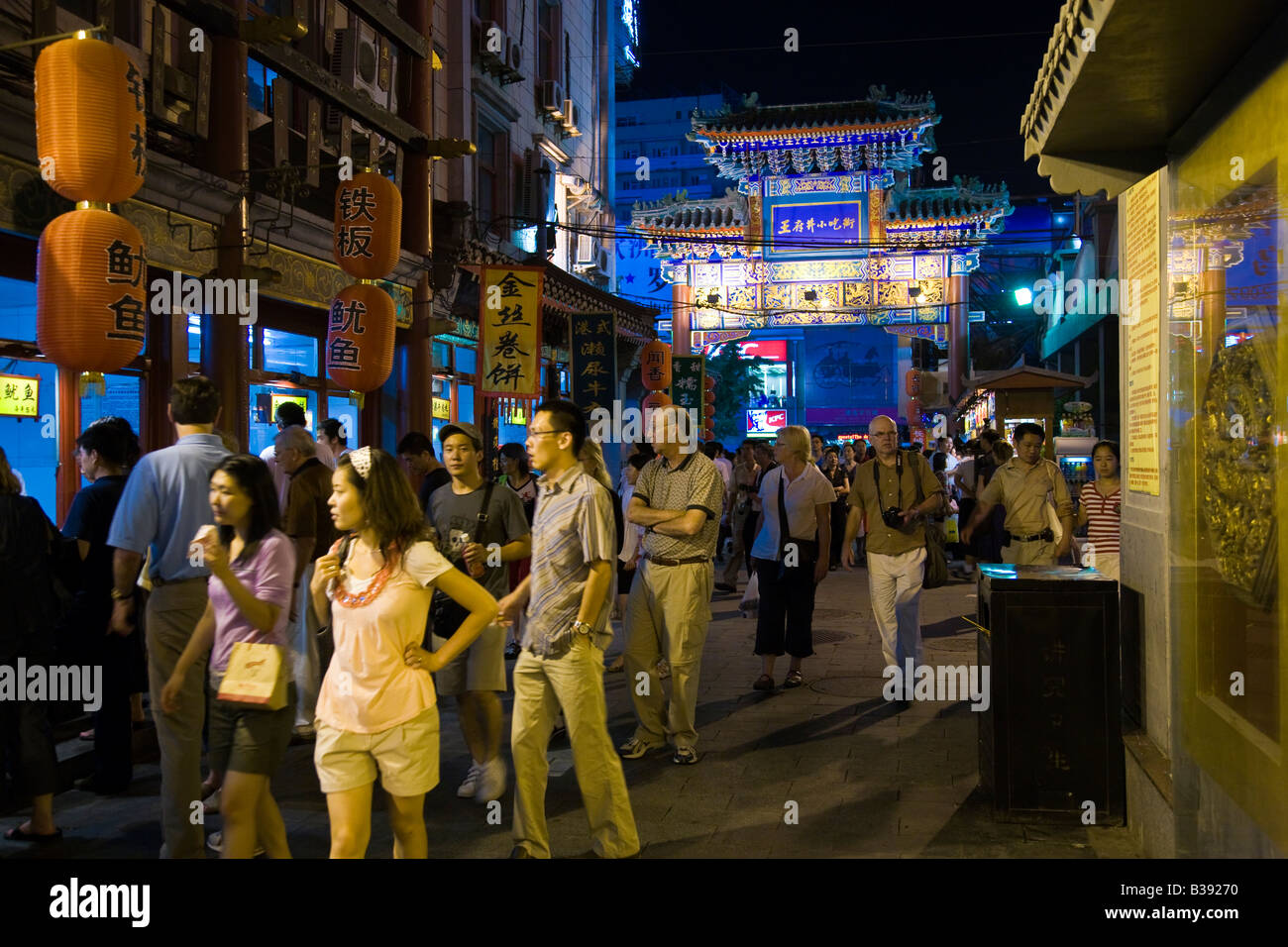 Chinese and foreigners mingle in Wanfujing Dajie Street Beijing's main shopping street at night JMH3189 Stock Photo
