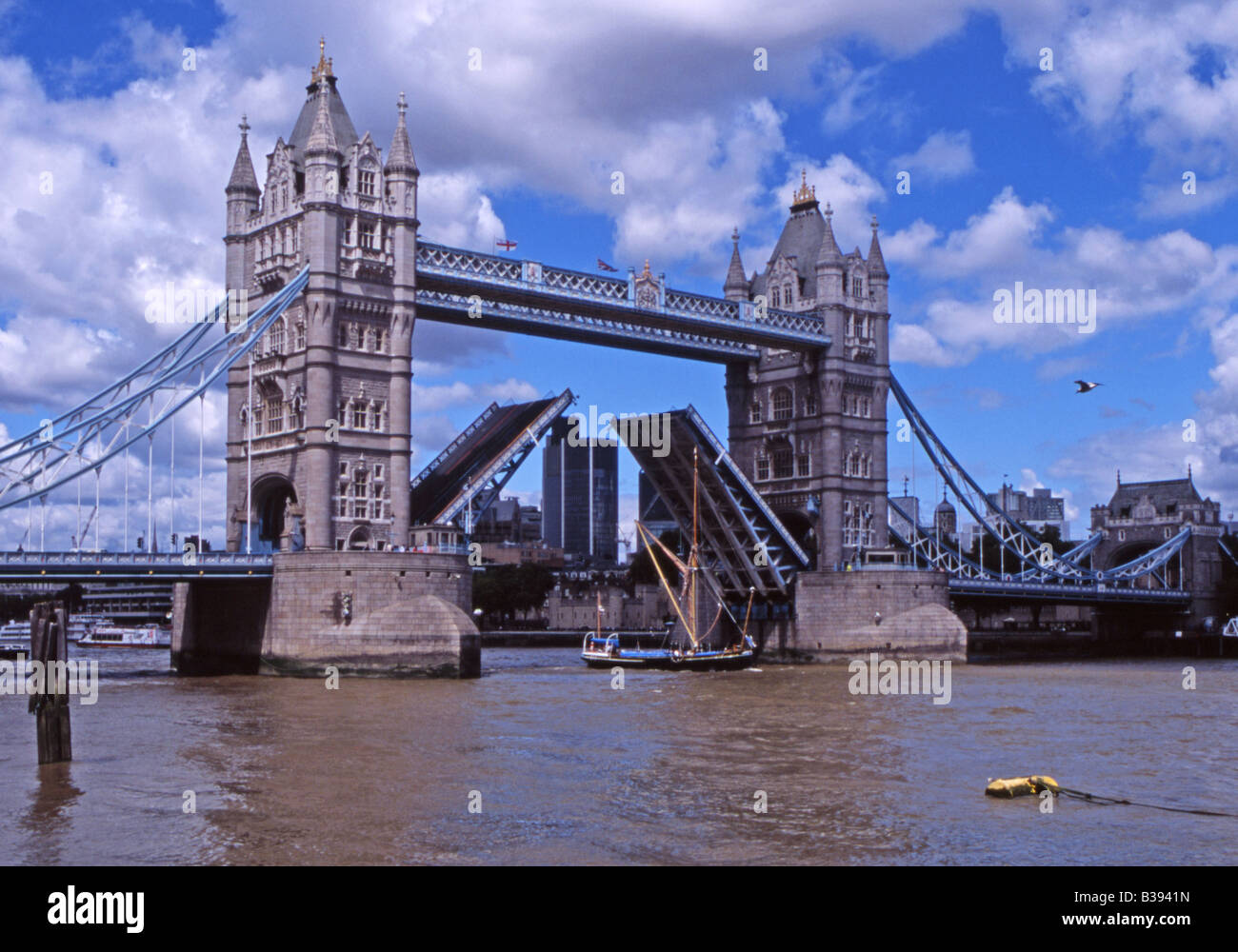 A traditional Thames sailing barge passes through London's Tower Bridge