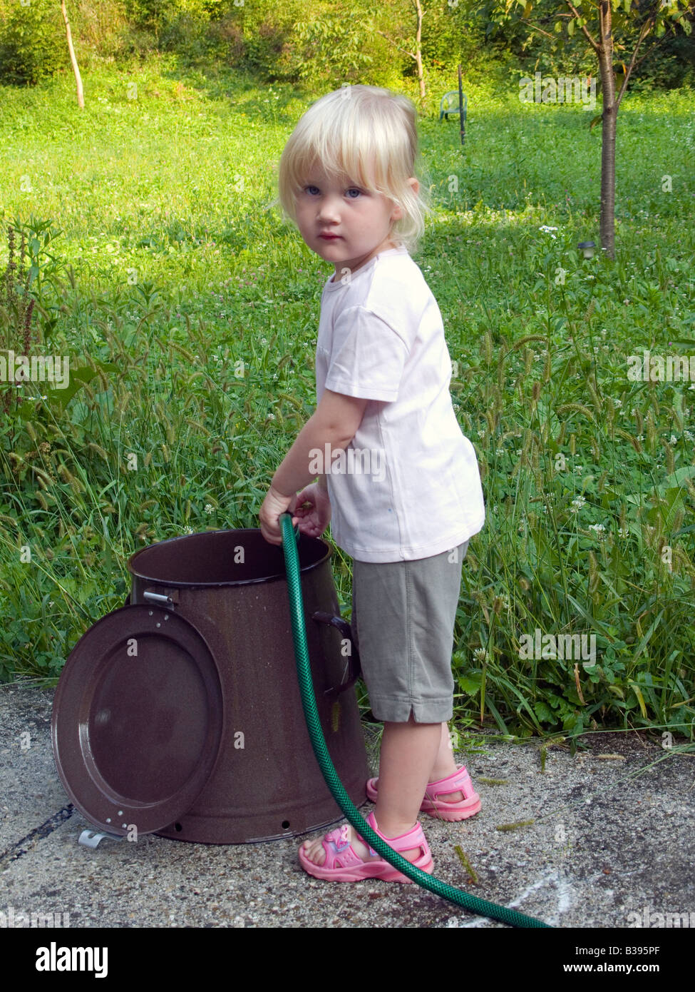 Girl washing clothes in small hi-res stock photography and images - Alamy