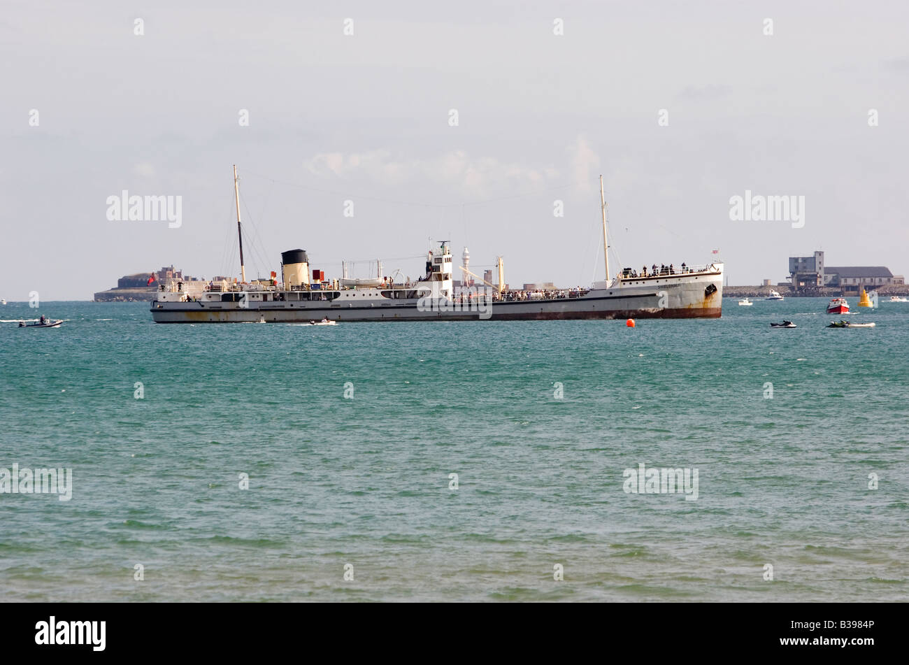 The steamship SS Shieldhall enters Weymouth Bay in front of the Portland Breakwater Stock Photo
