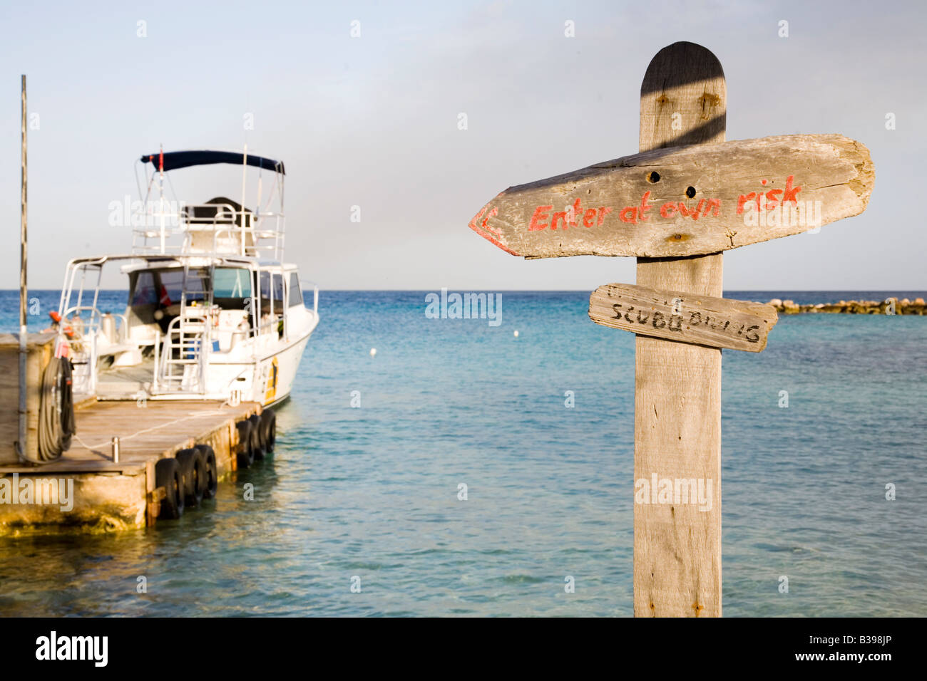 Boat and signpost at Piscadera Bay beach Curacao Netherlands Antilles Caribbean Stock Photo