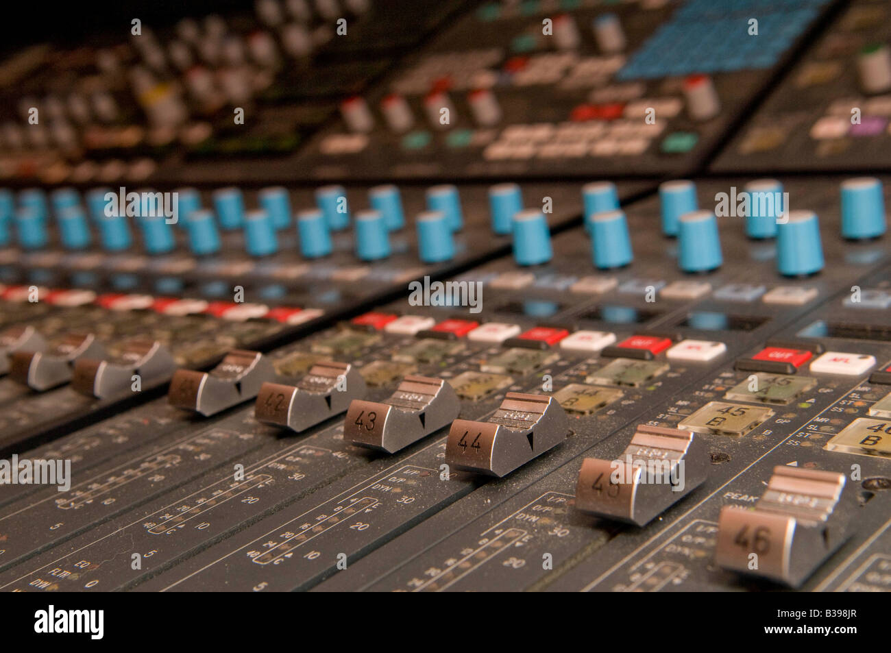 calrec audio mixing console showing the faders Stock Photo